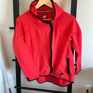 Bright red, hi/low zip up with hood. Zipper is off to the side.